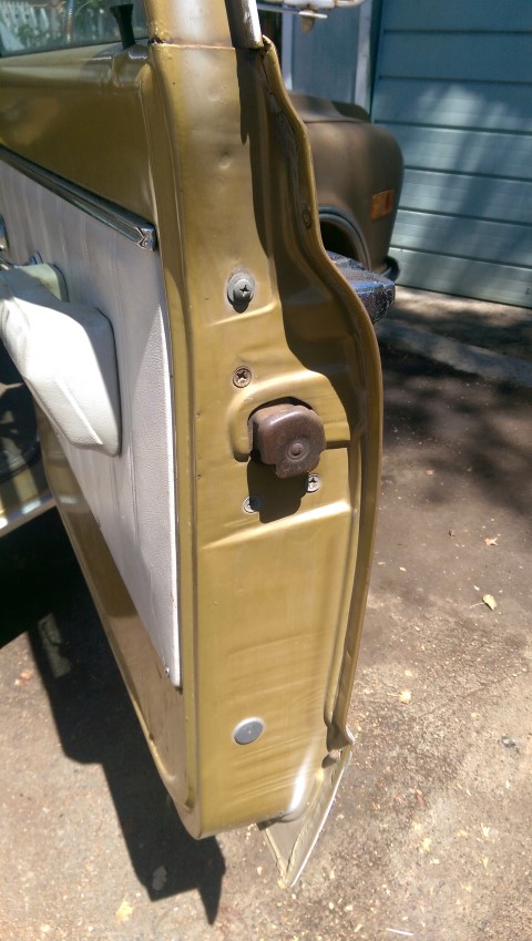 1968 Chevrolet C/K Pickup - The interior and exterior of a vehicle's door are shown, with a focus on the lock mechanism.