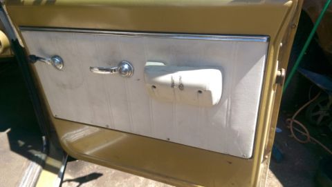1968 Chevrolet C/K Pickup - Interior view of a vintage truck door panel, showing wear and tear on the armrest and door handle area.