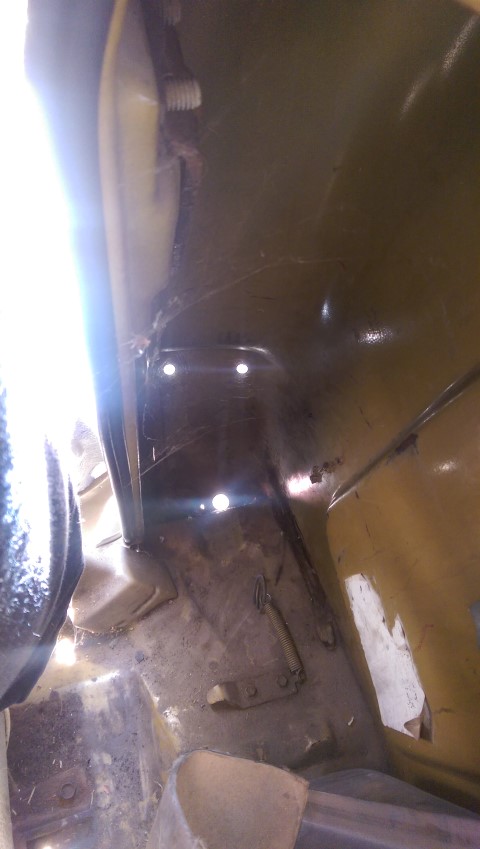 1968 Chevrolet C/K Pickup - Close-up view of the interior floor pan and mounting hardware within a vehicle.