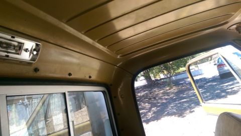 1968 Chevrolet C/K Pickup - View from inside a truck cab shows the interior and a glimpse of the exterior with another vehicle.