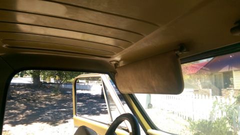 1968 Chevrolet C/K Pickup - Interior view of a vintage truck cab, highlighting the headliner and sun visor.