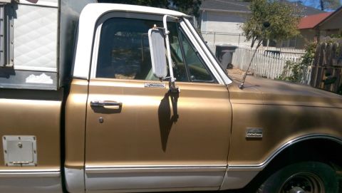 1968 Chevrolet C/K Pickup - Side view of a 1968 Chevrolet C/K Pickup truck with a camper shell.