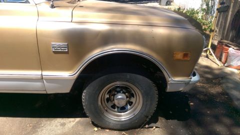 1968 Chevrolet C/K Pickup - Close-up of the front fender and wheel of a vintage pickup truck.