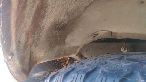 1968 Chevrolet C/K Pickup - Close-up view of a rusty truck wheel well and tire, with a Supermotors watermark.