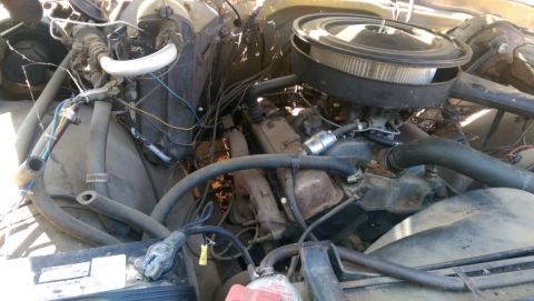 1968 Chevrolet C/K Pickup - The engine bay of a vehicle, showing various components and wiring.