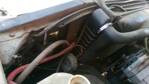 1968 Chevrolet C/K Pickup - Close-up view of the engine bay, showing hoses, wiring, and part of the radiator.