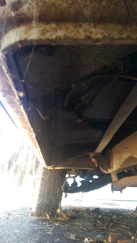 1968 Chevrolet C/K Pickup - Underside view of a 1968 Chevrolet C/K Pickup truck bed and frame, showing rust and undercarriage components.