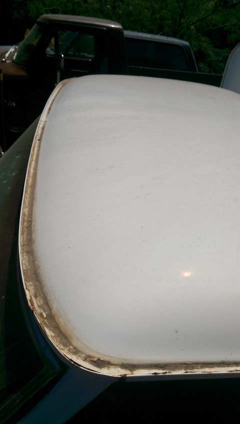 1968 Chevrolet C/K Pickup - A close-up of a white truck roof with visible weathering along the edge, with another truck in the background.