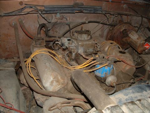 1988 Ford F-150 - The engine bay of a 1988 Ford F-150 shows a V8 engine with visible carburetor and distributor.