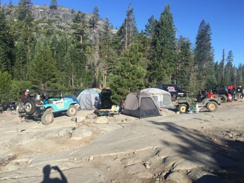 1946 Jeep CJ5 - Several Jeeps are parked at a campsite in a mountainous, wooded area during the Jeepers Jamboree 2015 event.