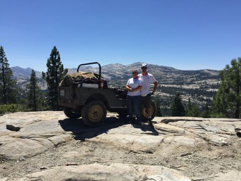 1946 Jeep CJ5 - A couple poses with their vintage Jeep on a scenic mountain overlook.
