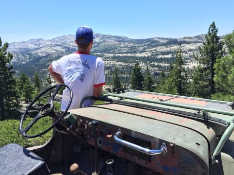 1946 Jeep CJ5 - A person looks out at a mountain vista from the interior of a 1946 Jeep CJ5.