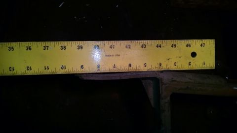 1992 Ford Bronco - A yellow ruler is placed over a dark component, with measurements visible in inches.