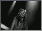 1990 Ford Bronco - A black and white photo captures a woman with long hair illuminated by stage lights.