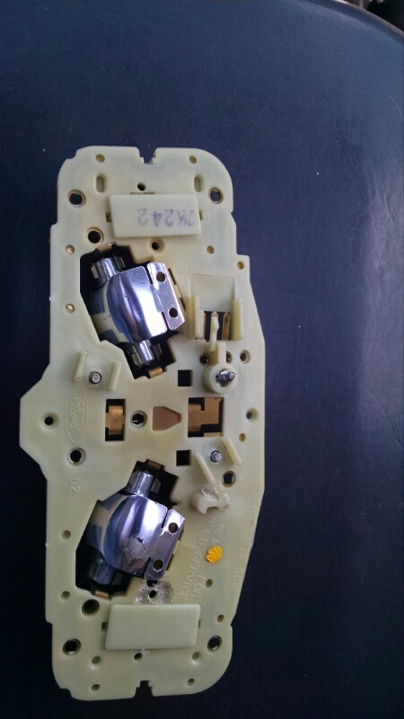 1992 Ford Bronco - This is a dome light assembly for a Ford Bronco, showing the bulb sockets and electrical contacts.