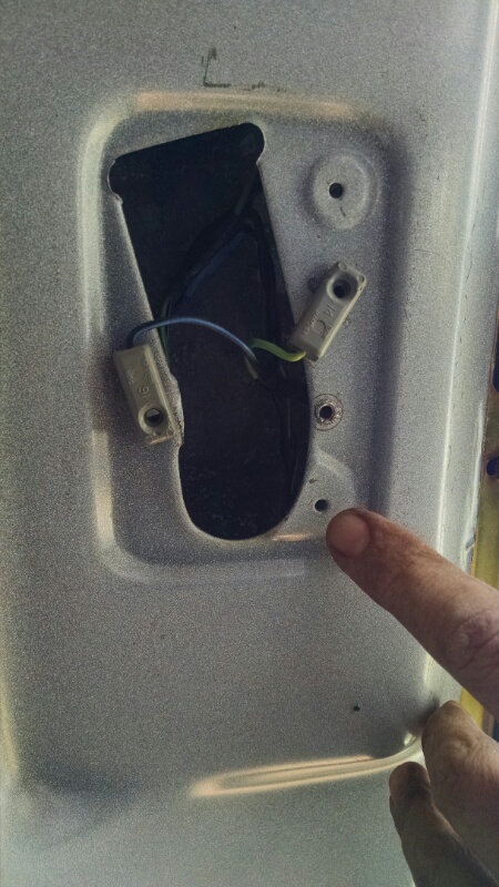 1992 Ford Bronco - Close-up of an interior door panel showing wiring and mounting holes, likely for a dome light.