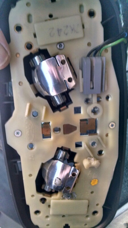 1992 Ford Bronco - Close-up view of the interior dome light assembly, showing the bulb sockets and electrical connectors.