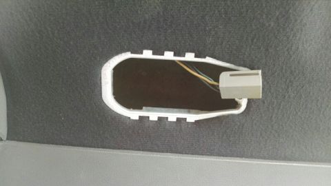 1992 Ford Bronco - Close-up of an interior trim panel showing a wiring harness connector and exposed wires.