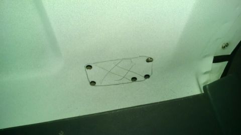 1992 Ford Bronco - A close-up view of a vehicle's interior panel, showing a hand-drawn outline with several drilled holes.