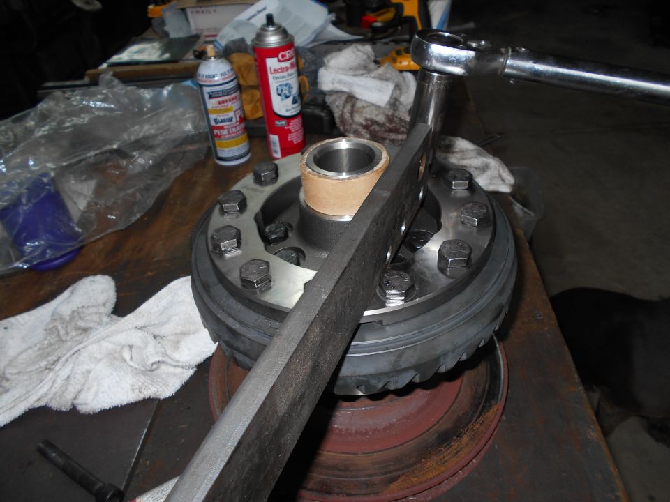 Differential carrier being worked on with a torque wrench and spray cans