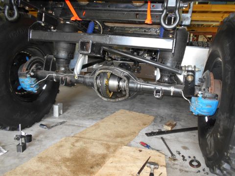 1992 Ford Bronco - Close-up view of a vehicle's rear axle and suspension system during repair work.