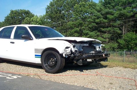 2001 Ford Crown Victoria - This 2001 Ford Crown Victoria shows significant damage to its front end, including the grille and hood.