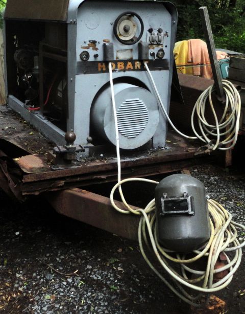 2006 Ford F-250 - A Hobart welder and a welding mask are seen on a trailer, with coiled cables.