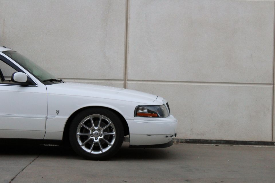 White 2000 Mercury Grand Marquis, front quarter view, chrome wheels
