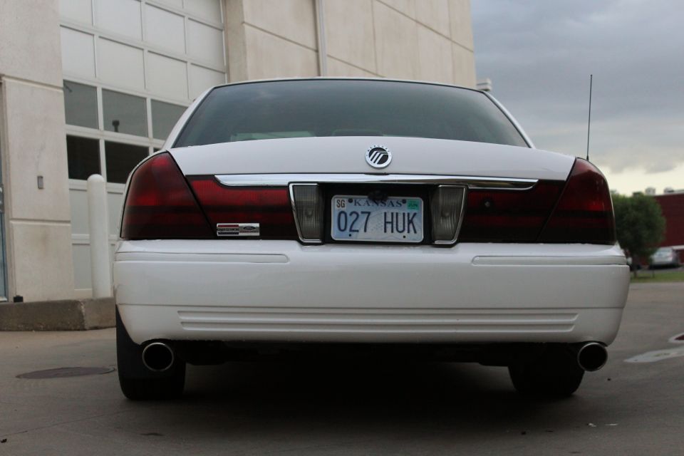 Rear view of a white 2000 Mercury Grand Marquis with a Kansas license plate