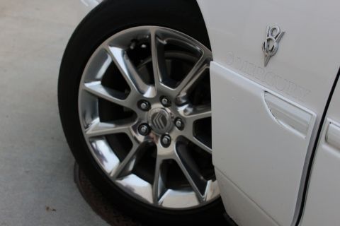 2000 Mercury Grand Marquis - 2000 Mercury Grand Marquis wheel and fender emblem detail.