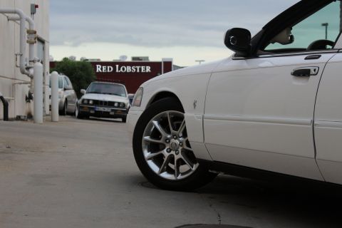 2000 Mercury Grand Marquis - A white sedan is parked in front of a Red Lobster restaurant, with another vehicle in the background.