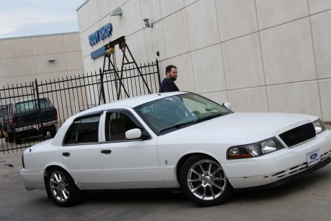 2000 Mercury Grand Marquis - White 2000 Mercury Grand Marquis parked in front of a body shop.
