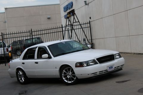 2000 Mercury Grand Marquis - White 2000 Mercury Grand Marquis with aftermarket grille and wheels.