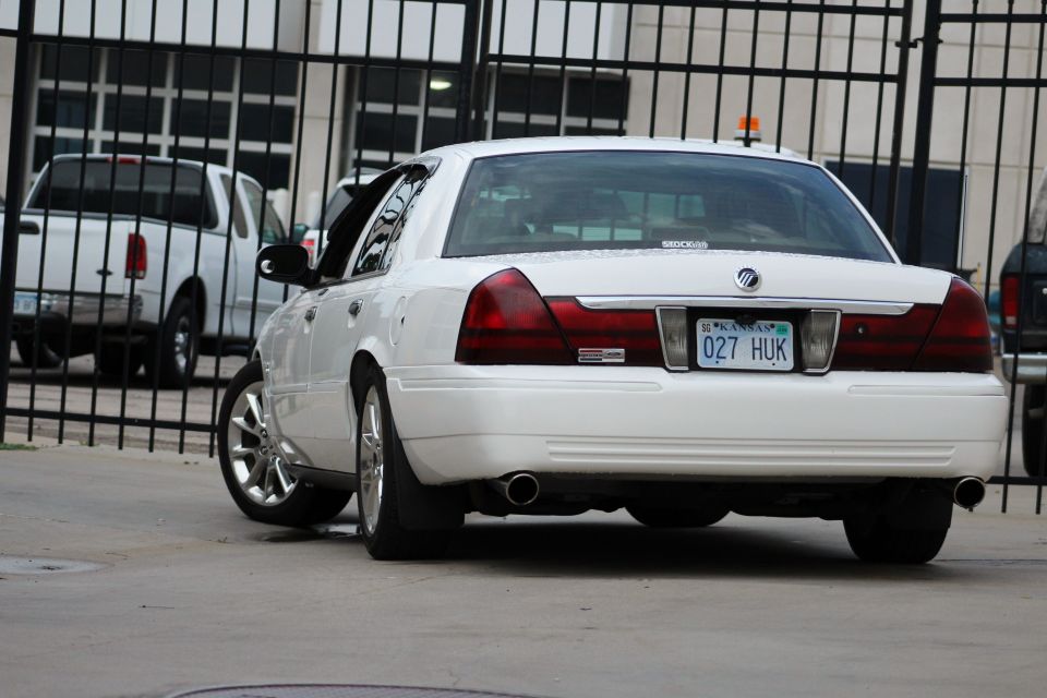 White 2000 Mercury Grand Marquis rear view with custom wheels and dual exhaust