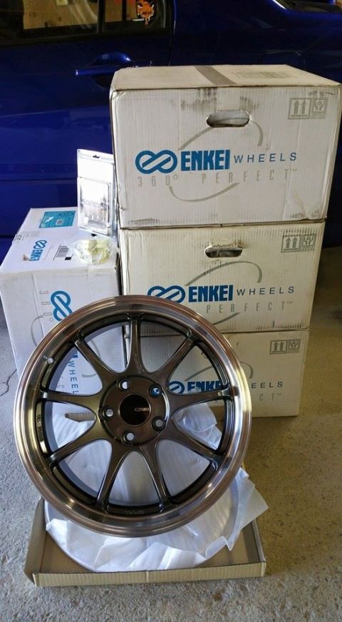 2006 Mitsubishi Evolution - New Enkei wheels in boxes, one bronze wheel displayed in front.