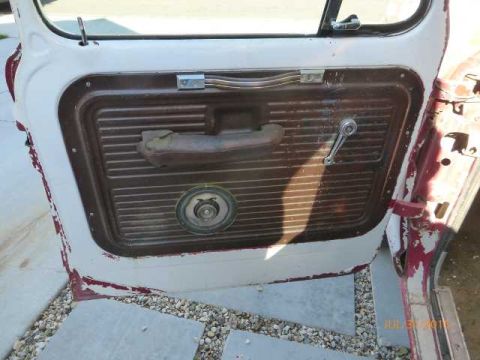 1970 Ford F-250 - The interior door panel of a 1970 Ford F-250 shows its ribbed texture and chrome window crank.