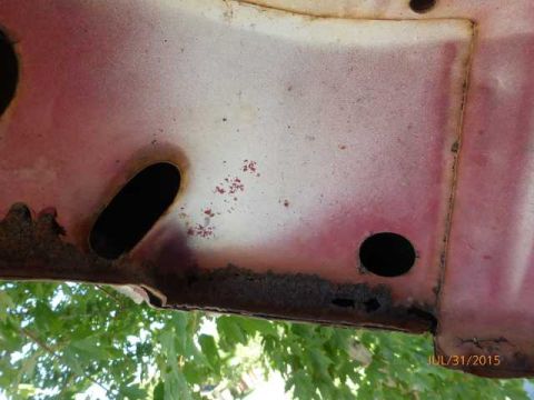 1970 Ford F-250 - This close-up shows a section of rusted metal with two holes, possibly from a vehicle's body.