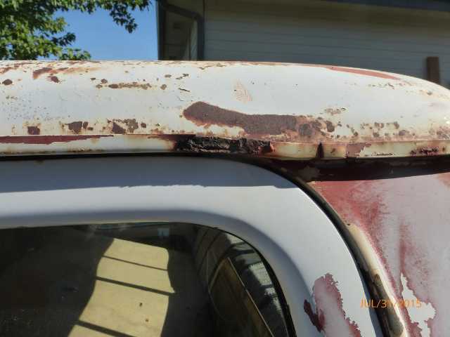 White truck roofline with extensive rust and peeling paint