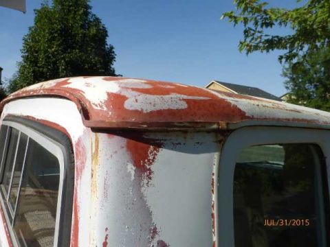 1970 Ford F-250 - The weathered roof of a 1970 Ford F-250 shows significant rust and peeling paint.