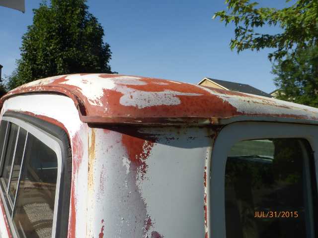 1970 Ford F-250 cab roof with peeling paint and rust