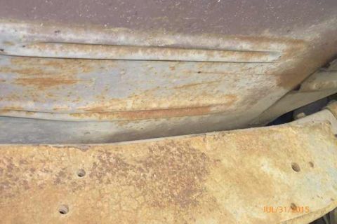 1970 Ford F-250 - Close-up view of aged and corroded vehicle undercarriage parts, with visible rust and wear.