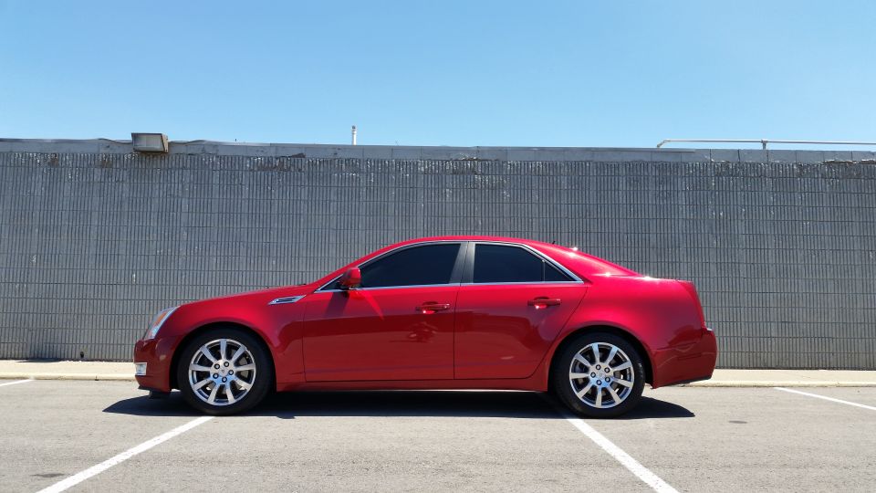 Red 2008 Cadillac CTS sedan parked in a lot.