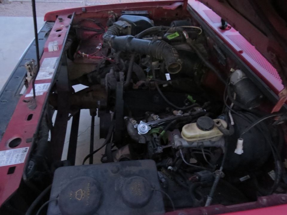 1992 Ford Ranger engine bay with red exterior paint.
