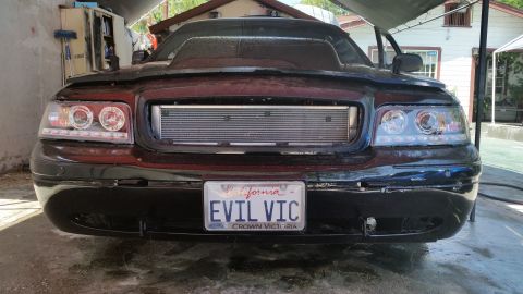 2003 Ford Crown Victoria - Photograph of a modified black Ford Crown Victoria front end, not a technical document.