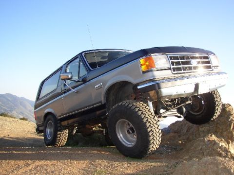 1989 Ford Bronco - This 1989 Ford Bronco is shown navigating a rocky incline under a clear blue sky.
