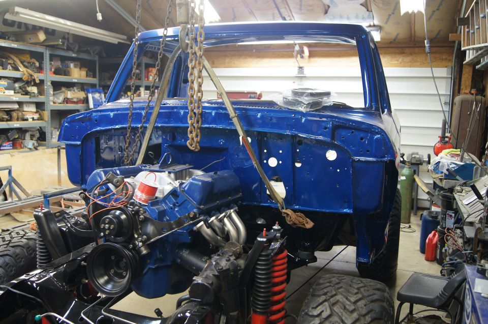 Back of body was lifted by hand and carried sideways over the frame with trolley rolling the front of body over the frame.