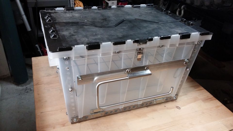 Plastic storage bin with metal reinforcements and handle