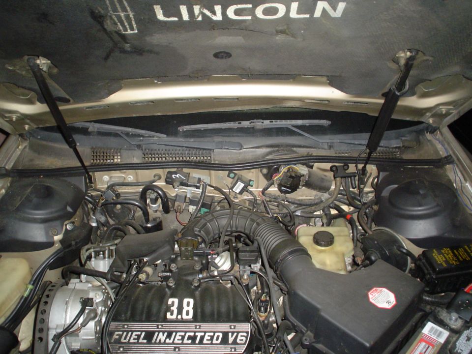 Engine bay of a Lincoln showing 3.8L Fuel Injected V6 with hood open