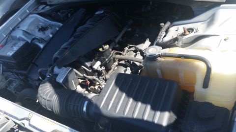 2001 Ford Crown Victoria - Close-up view of a vehicle's engine bay, showing the air intake system and coolant reservoir.