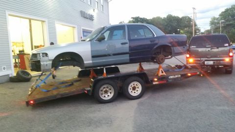 2001 Ford Crown Victoria - Ford Crown Victoria being transported on a trailer, with an SUV towing it.